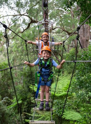 Father and son on Zipline Line suspension bridge at Zipline at Illawarra Fly in Jamberoo, Kiama