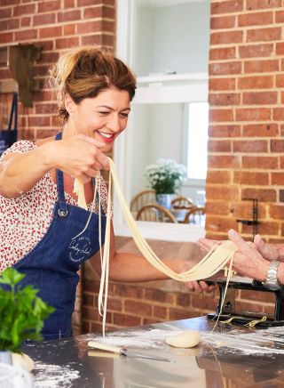 Couple enjoying a cooking experience with Tamara Howorth at The Little Cooking School, Mudgee