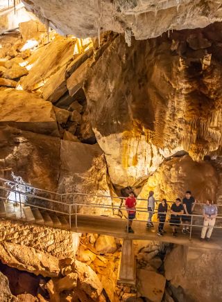 Small group enjoying a tour through a cave system at Jenolan Caves, Blue Mountains