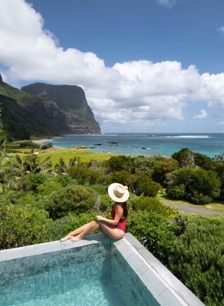 Woman enjoying pool at Capella Lodge, Lord Howe Island