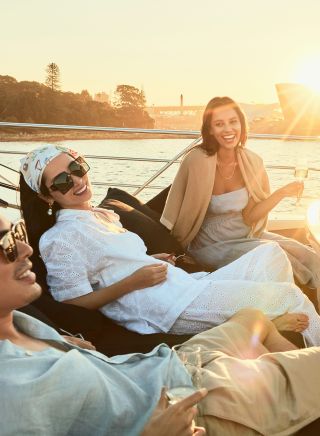 Group enjoying harbour view from Ghost 2 Super yacht, Sydney Harbour