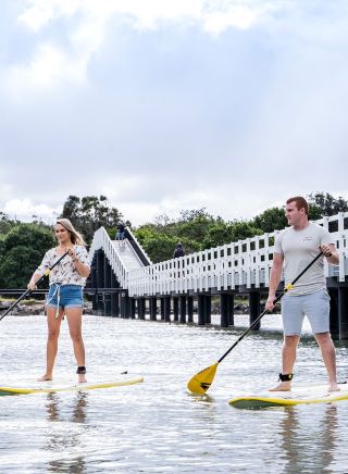 Couple enjoying a stand up paddleboarding experience with SWR SUP along Back Creek, South West Rocks