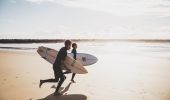 Surfers heading out for a morning surf at Turners Beach in Yamba, Clarence Valley