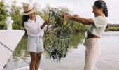 Women holding their catch during a Catch A Crab boat tour on the Tweed River, West Tweed Heads