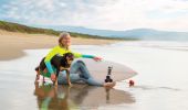 Woman and her pet dog out for a morning surf at Shoalhaven Heads on the South Coast