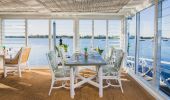 The interior of the Whalebone Wharf seafood restaurant with views across Hastings River, Port Macquarie, North Coast