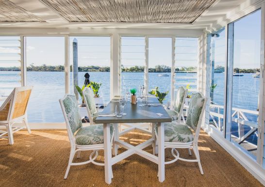 The interior of the Whalebone Wharf seafood restaurant with views across Hastings River, Port Macquarie, North Coast