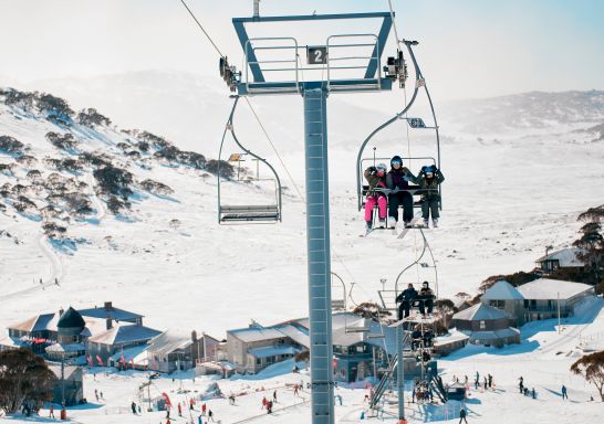 Skiiers riding the chair lifts at Charlotte Pass Ski Resort in the Snowy Mountains.